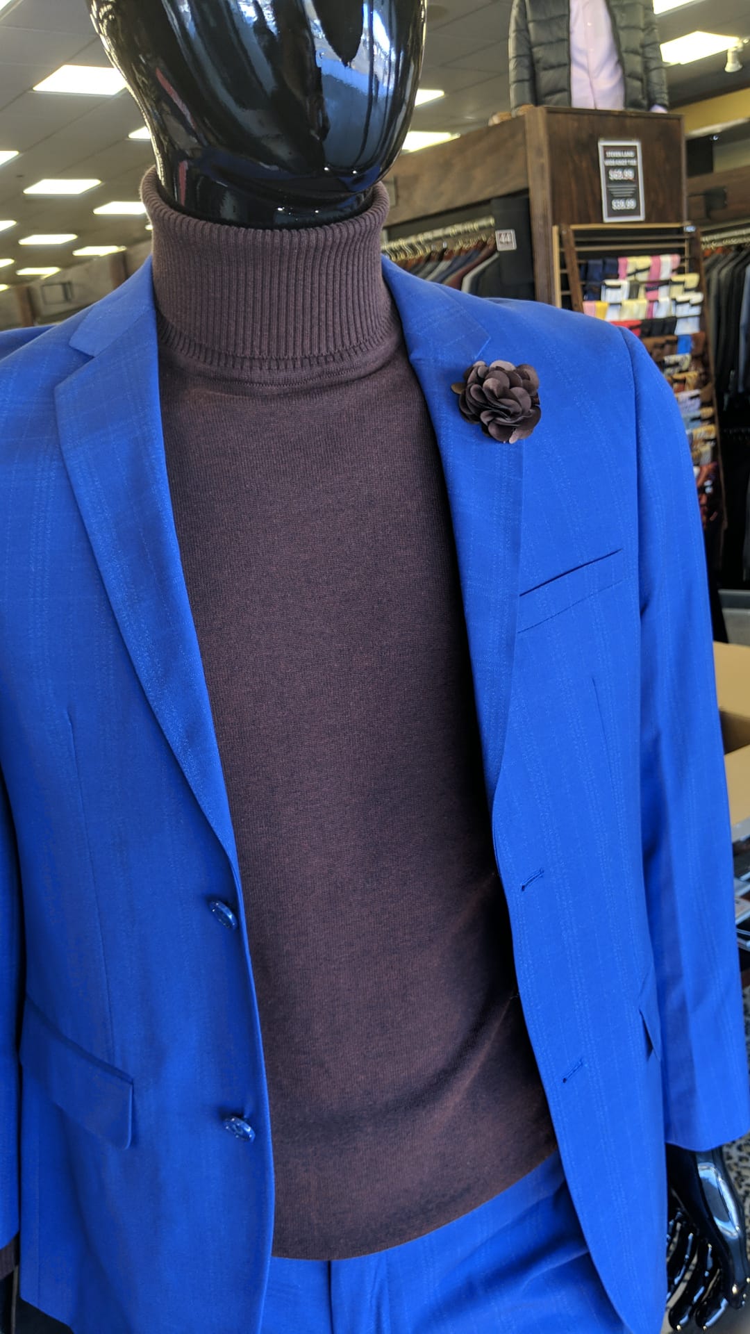 photo of blue suit with gray turtleneck on mannequin